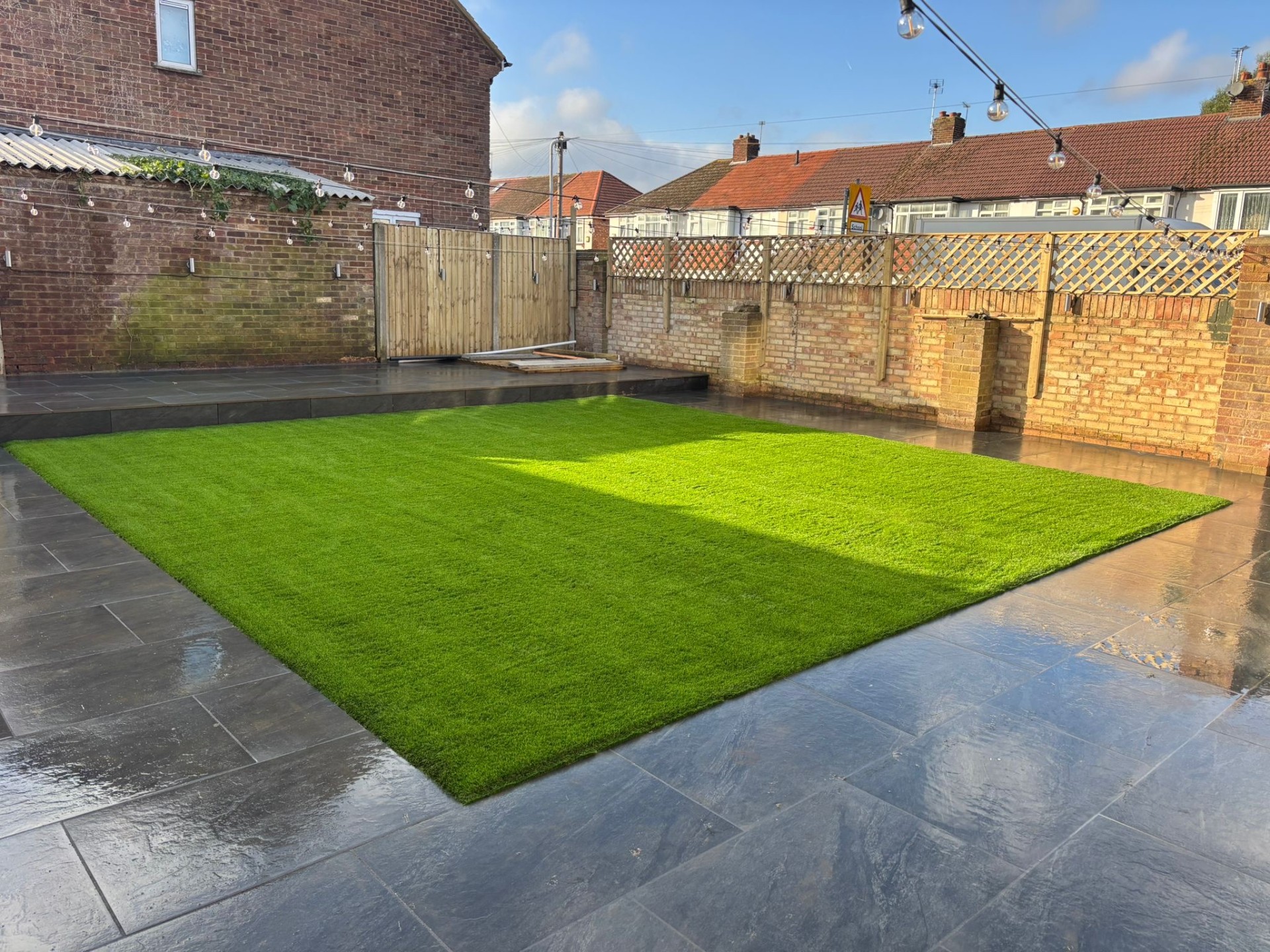 Patio garden with festoon lights in Berkhamsted