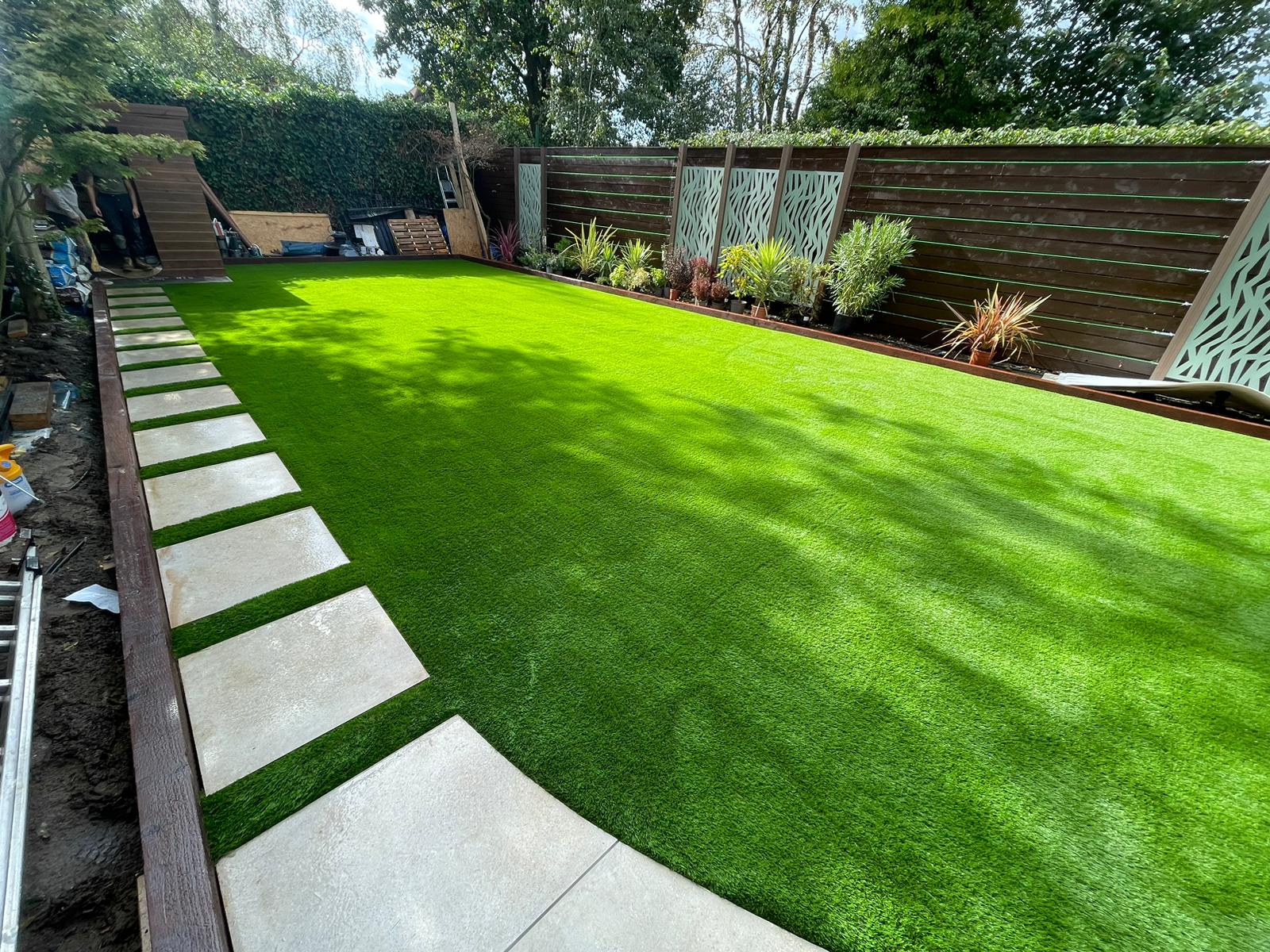 Large lawn with stepping stones in Finchley