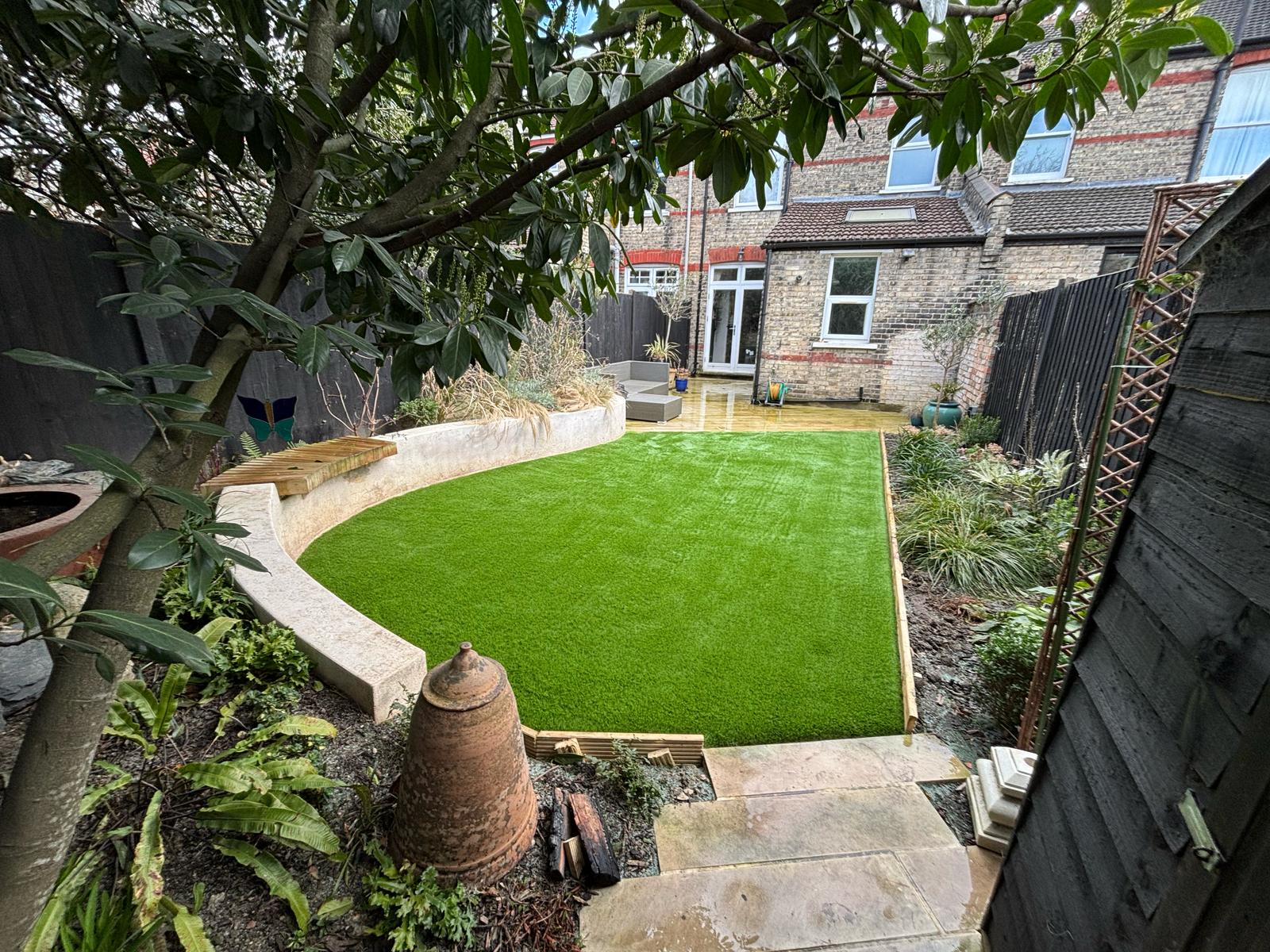 Curved lawn with mature tree in Harrow