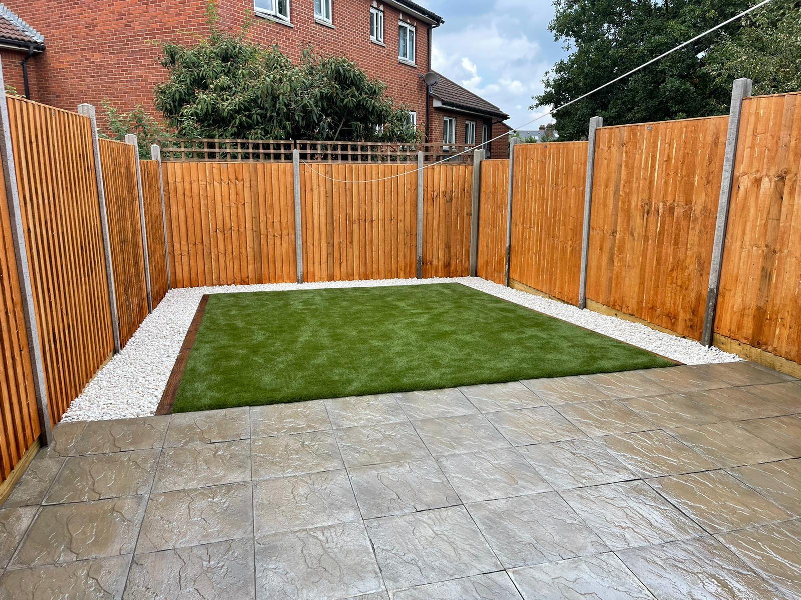 Compact patio lawn with gravel border in Ilford