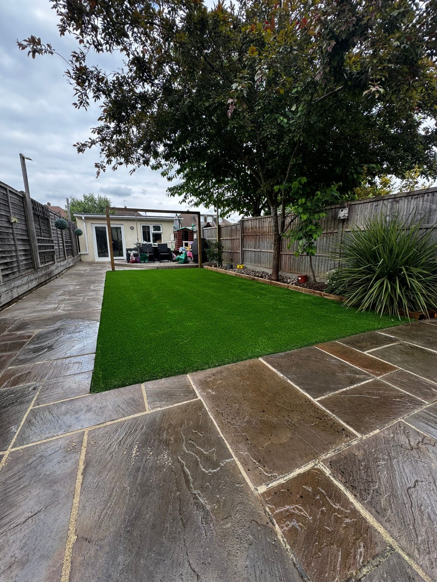 Family garden with mature tree in Watford